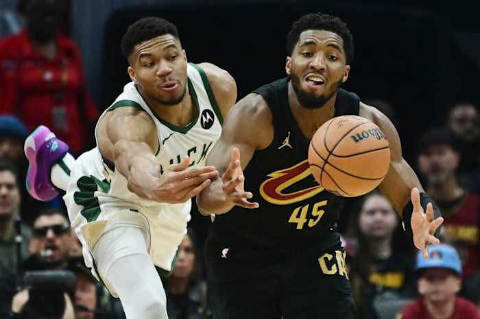 December 29, 2023; Milwaukee Bucks forward Giannis Antetokounmpo and Cleveland Cavaliers guard Donovan Mitchell fight for a loose ball